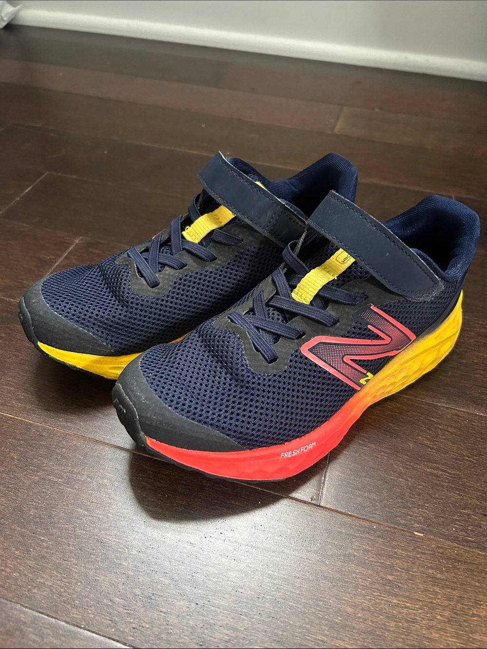 New Balance Kids Navy Sneakers with Yellow & Red Accents